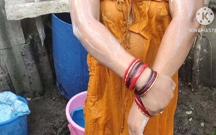 Indian house wife bathing outside with