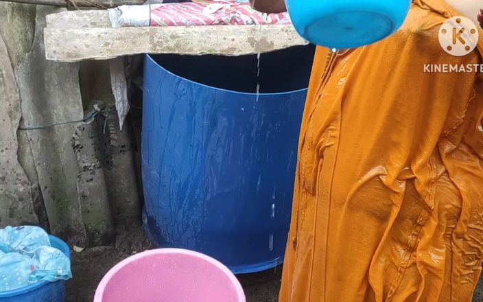 Indian house wife bathing outside